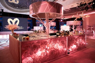 “A modern interpretation of a tree is in the center of the bar. The trunk is made of white painted birch branches and the top of the tree is a shallow drum with a stick pattern printed in pink and white and the inside is lined with rose-gold glitter.” Pictured: Bat mitzvah at Mandarin Oriental