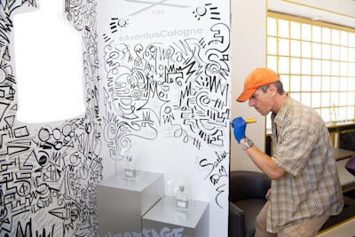 Artist Todd Serlin decorates the wall located at the Beverly Hills store.