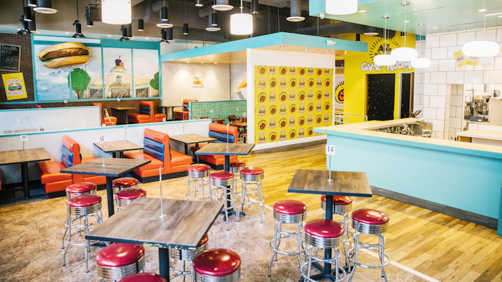 To promote the return of Nickelodeon's All That sketch comedy series, the network opened a pop-up dining experience this week that's inspired by the old Good Burger sketch starring Kenan Thompson and Kel Mitchell. Open through the end of 2019, the nostalgic space—created by the same team behind the recent 'Saved by the Max' pop-up—serves food from local chef Alvin Cailan, founder of Eggslut. The pop-up, which was designed by multidisciplinary artist Floyd A. Davis IV, also has photo moments, games, merchandise, and, as fans can appreciate, plenty of orange soda.