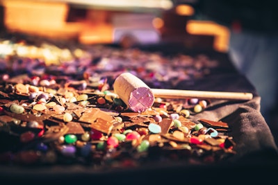 Guests use mallets to smash their customized chocolate slabs.