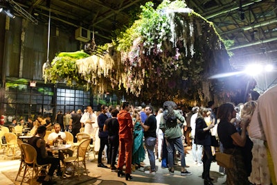 The V.I.P. kickoff event took place June 20. Guests mingled and sipped cocktails under the rear of the structure, where they could view FlowerCult's floral installation.