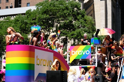 TV personality Andy Cohen doubled as a DJ for Bravo’s rainbow float, which featured Real Housewives cast members from all of the network’s franchises, as well as drag queens dressed as various housewives.