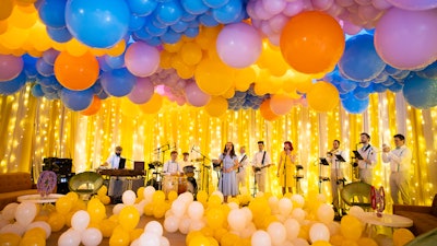 Hundreds of balloons filled the space, highlighting a performance by Dallas & Doll.
