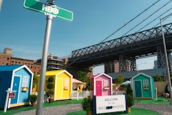 Four tiny houses were painted in blue, yellow, pink, and green, with each corresponding to a different movie genre. Tiny house materials were donated to Habitat for Humanity after the event.