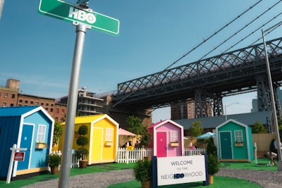 Four tiny houses were painted in blue, yellow, pink, and green, with each corresponding to a different movie genre. Tiny house materials were donated to Habitat for Humanity after the event.