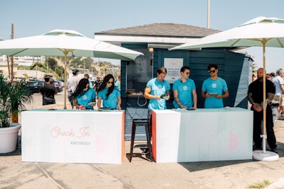 Brand ambassadors wearing blue shirts with the Instagram logo checked in guests. The check-in tables featured the 'Neon' font used in Instagram Stories.