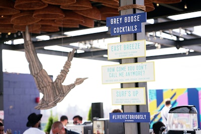 The event served cocktails inspired by Montauk, displayed on rustic beach signs. Event decor included a wooden, geometric goose.