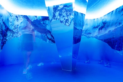 The 360-degree blue Mountain installation features photographs of snow capped mountaintops reflected in a quadrilateral mirror in the center.