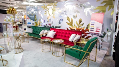 Blueprint Studios also created a holiday vignette, which featured the velvet Paladin sofa in shades of emerald green and rouge. (The product also comes in light taupe and blue, all accented with gold chrome.) Gold Le Cirque accent tables completed the look.