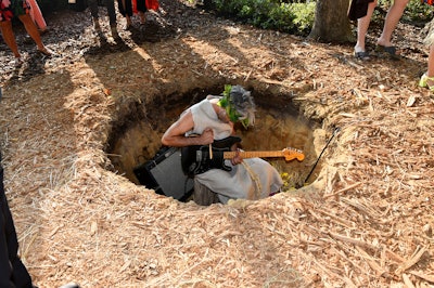 Guests rounding the corner were careful not to fall into Dom Bouffard's 'Help A Brother Out' installation. The British musician and musical collaborator to Robert Wilson performed continuously in a hole, scattered with hay and flowers.