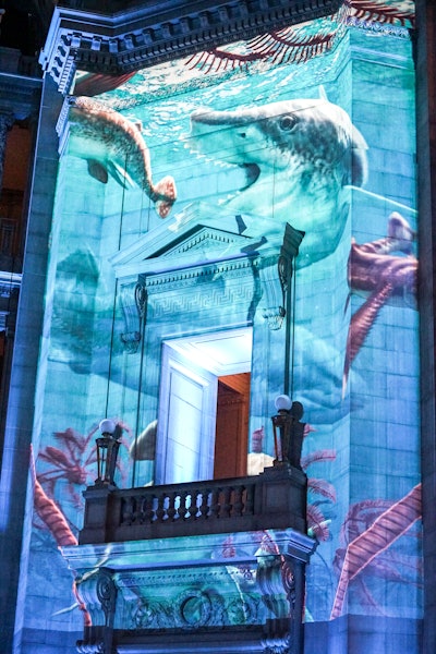 Projections on the walls during the dinner depicted scenes of the extinct world that visitors learn about in the exhibit, including marine life.