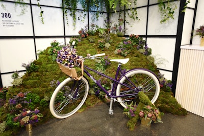 Nespresso recently partnered with Swedish bicycle manufacturer Velosophy to build a bike made from 300 recycled coffee pods. The bike is painted in the same bright purple as Nespresso's 'Arpeggio' coffee pod and features a pod-shaped bell and a cup holder basket. The bike was propped up in front of a moss-covered floral installation and served as a photo op for guests.