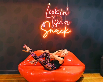 Cheeky photo ops included a rendering of the popular phrase 'Lookin' Like a Snack' rendered in neon, above a lip-shaped seat.