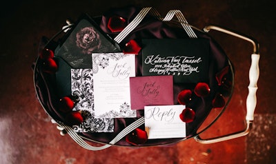 For a styled photoshoot at City Libre in Los Angeles, event designer Fathom Affairs created a Tim Burton-inspired wedding. Halloween-appropriate black, white, and red paper goods were designed by Calligraphy Nerd.