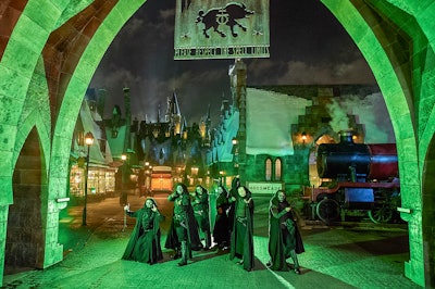 Throughout the park's Hogsmeade village, which is filled with spooky green lighting and fog during the Dark Arts shows, actors dressed as Death Eaters—followers of Harry Potter's villain, Voldemort—interact with guests.