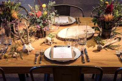 Guests ate a four-course meal of elevated camp culinary staples from Love Catering. Table settings featured a creepy mix of rustic florals and bones.