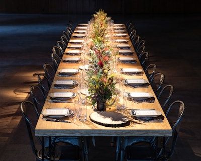 Attendees brought the hiker to the infirmary, then got ready for dinner in the camp's main lodge. The stylish dinner party took place at a communal table underneath rustic wagon-wheel chandeliers.