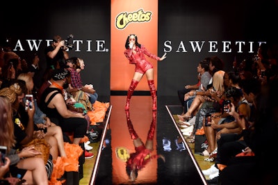 Rapper Saweetie performed on the runway, wearing her own Cheetos-inspired getup.