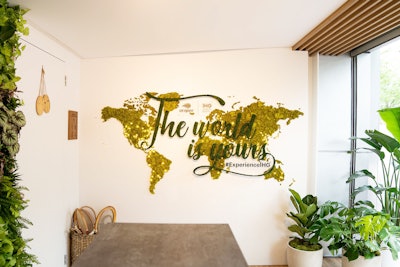 Design elements include a world map created with moss that displays an I.H.G. tagline and hashtag.