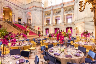 For the dinner held inside San Francisco City Hall, Blueprint Studios used textured table linens and hot-pink velvet draping and carpet.
