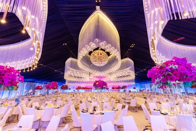 The Patrons Pavilion featured custom-fabricated fringe chandeliers, weighing 12,000 pounds, highlighted by more than 3,000 cascading gold pendants. White leather seating and tall floral arrangements completed the look.