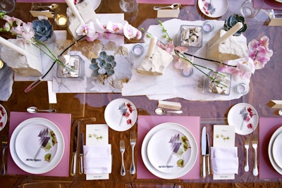 The soft mauve tablescape featured customized plates with gilded flatware by the Tabletop Company, desert rock centerpieces, and towering white and pink orchids.