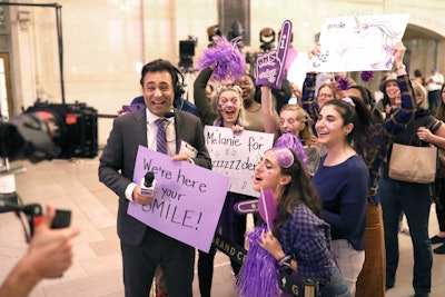 At one point, actors dressed as fans cheered on Melanie. The story was narrated by actors dressed as news anchors.