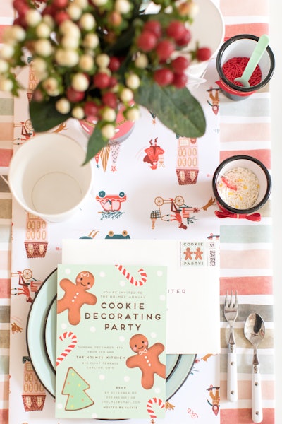 At this year's Minted holiday preview event, festive wrapping paper and holiday cards served as tabletop decor for a fun cookie decorating party idea.