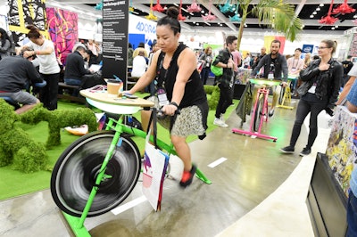 Rock the Bike, based in Oakland, California, brings bicycle-powered activities to events throughout the continental United States. The company offers the Recharge Station, a bike that can charge as many as eight phones at once, and offer a fun icebreaker and stress relief option at conferences such as Adobe Max in 2018 (pictured). An integrated 'pedalometer' shows attendees how hard it is to pedal to maintain consistent charging. The desk and wheels can be branded with company logos and custom colors.
