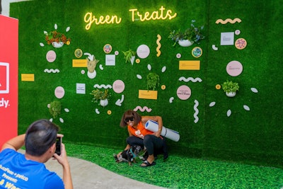 A green photo wall highlighted Petco's natural products.