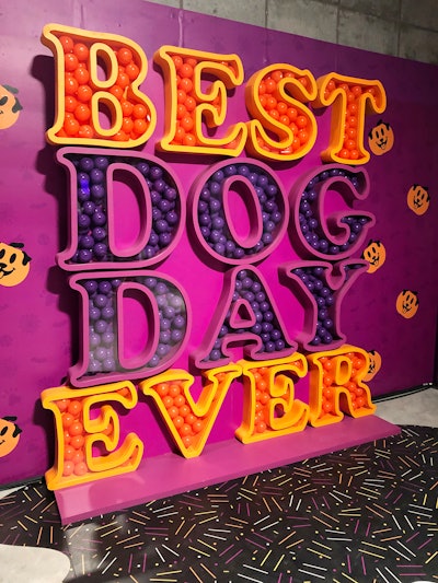 The event's orange and purple step and repeat was created with block letters filled with plastic balls.