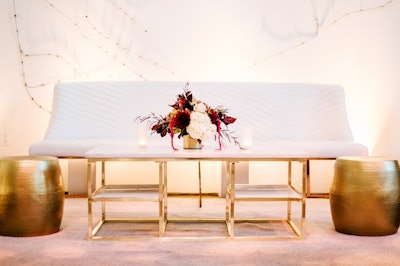 The crisp white Zephyr banquette sofa (pricing available upon request) with rose gold legs from Blueprint Studios is a cool lounge seating option for cocktail-style parties.