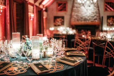 “We suggest using equal parts shine, sparkle, and velvet to create a table that is radiant and inviting this holiday season,” says Christine Traulich, founder and creative director of RedBliss Design (Pictured: menus, name plates, and chargers by RedBliss.)