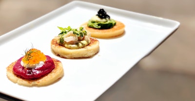 This decadent blini trio from Limelight includes the petite hors d'oeuvres topped with beet, crème fraîche, trout roe, and dill; watercress, oyster mayonnaise, and caviar; and smoked sturgeon, sauce gribiche, and chervil.