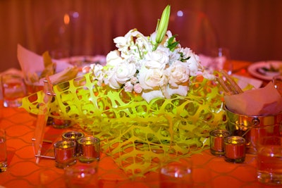 Centerpieces included yellow fencing paired with white flowers; additional seating arrangements included sawhorse tables with copper pipe centerpieces.