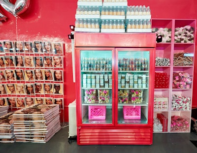 The raw space was transformed by HL Group’s event team with nods to the classic New York City bodega, including fridge cases that served as product display areas, branded grocery items like water bottles and paper towels, and hot pink milk crates. A newsstand-inspired step-and-repeat built with custom-branded magazines became a natural photo moment for guests.