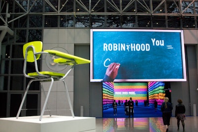 For this year's Robin Hood Benefit, held in New York in May, the nonprofit worked with David Stark Design & Production to create a 'Robin Hood to the Power of You' theme. The design included math-related classroom components, including an oversize desk and chair—with the organization's logo cleverly etched classroom-vandal style underneath the desk—and a digital blackboard with a hand writing messages tied to the foundation's mission. Other highlights included a tunnel of 7,000 backpacks displayed in colorful rows, plus math learning toys as centerpieces. (The backpacks and toys were donated after the event.)
