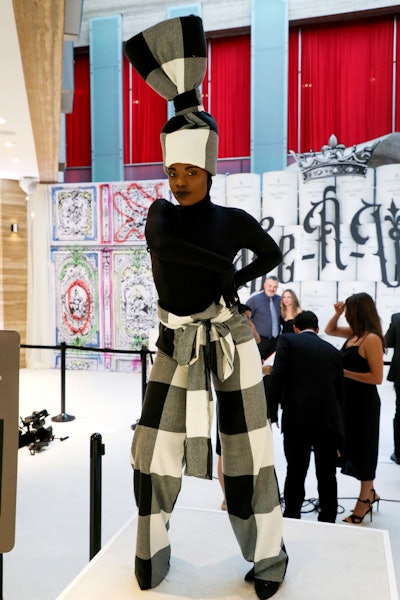 Jean Paul Gaultier-inspired costumed greeters posed alongside guests at the entrance.