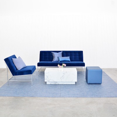 Taylor Creative’s Aston Collection is upholstered in a rich blue micro velvet for a sophisticated take on the color of the year. The set includes a sofa ($450) and chair ($250) and is shown with the rental company’s new Chilewich floor mat in denim ($250) and the Oscar cube in Quilt Blue ($85). All prices include up to a five-day rental period; items are available in New York.