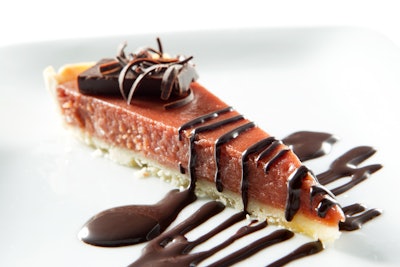 Blood orange cardamom tart with chocolate truffle and dark chocolate sauce, by D’Amico Catering in Minneapolis