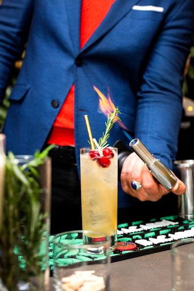 A brand ambassador guided guests through rum tastings and showed them how to make holiday cocktails like the Arbolito. The drink consists of Bacardi 4 shaken with white cranberry syrup and lemon juice, topped with soda water and clothes-pinned torched rosemary. It's served over ice in a Collins glass with a fresh cranberry garnish.