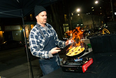 Chef Chris Brown of Victor Dries Catering spent the evenings cooking outdoors. In addition to the multi-course dinners served inside the container, Brown handed out samples of Cuban stew to some 330 passersby throughout the duration of the pop-up.