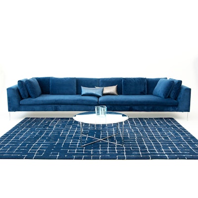 The regal Hudson Loveseat sectional from Taylor Creative, which is made up of a left-facing and a right-facing loveseat, makes a dramatic statement piece when paired together ($425 per piece) or can be rented individually for smaller spaces. Two loveseats create a 13-foot sofa. It's pictured here with the company’s navy net area rug ($400). All prices include up to a five-day rental period; items are available in New York.