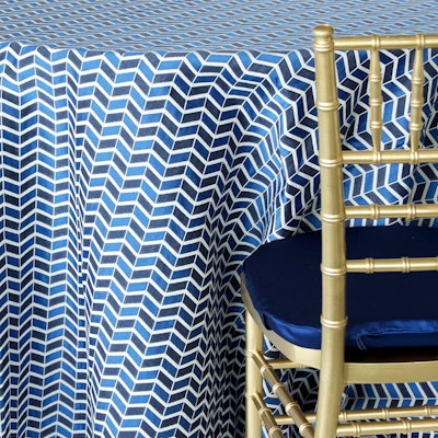 This striking graphic patterned linen from Nuage Designs features a navy arrowhead design and comes in a range of sizes, with pricing starting at $35. The linen is available for rent through the U.S.