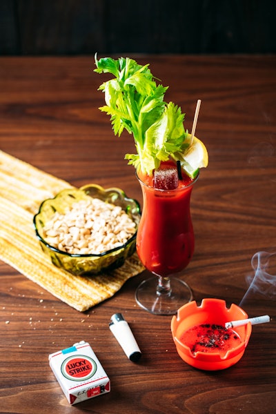 'Cliff's Bloody Mary,' inspired by Once Upon a Time in Hollywood, is made with vodka, tomato juice, Harvey's Bristol Cream sherry, Tabasco sauce, Worcestershire sauce, celery salt, and black pepper. It's topped with lemon and lime wedges and a celery stalk for garnish.