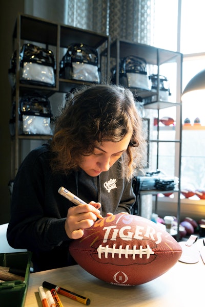 Arak said the activation that created the most buzz was these limited-edition regulation-size branded footballs that were hand painted on site by local lettering artist Ashlee Jones.