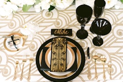 This gold Deco table linen from Nuage Designs features the architectural details reminiscent of the era. (Pictured here at an event designed by Sapphire Events New Orleans.) The items range in price from $15 for a pillow to $95 for a rectangular tablecloth.