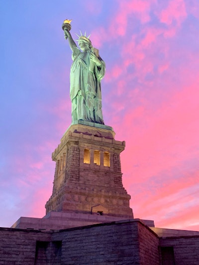 Sun Setting Behind the Statue of Liberty