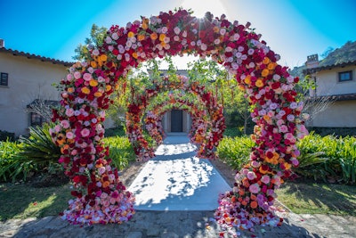 Guests entered the party through a series of floral archways, which led to a living garden ceiling with a mirrored walkway. Decor came from Revelry Event Designers, and rentals from Bright Event Rentals.