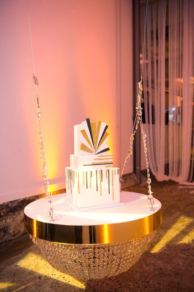 For this 21st birthday party, held at Longview Gallery in Washington in January 2017, Evoke Design & Creative created a 1920s-inspired bash, complete with a secret doorway, password, absinthe bar, and glitzy geometric cake from Buttercream Bakeshop that rested on a chandelier-like platform. Decor was provided by Revolution Event Design and Production.